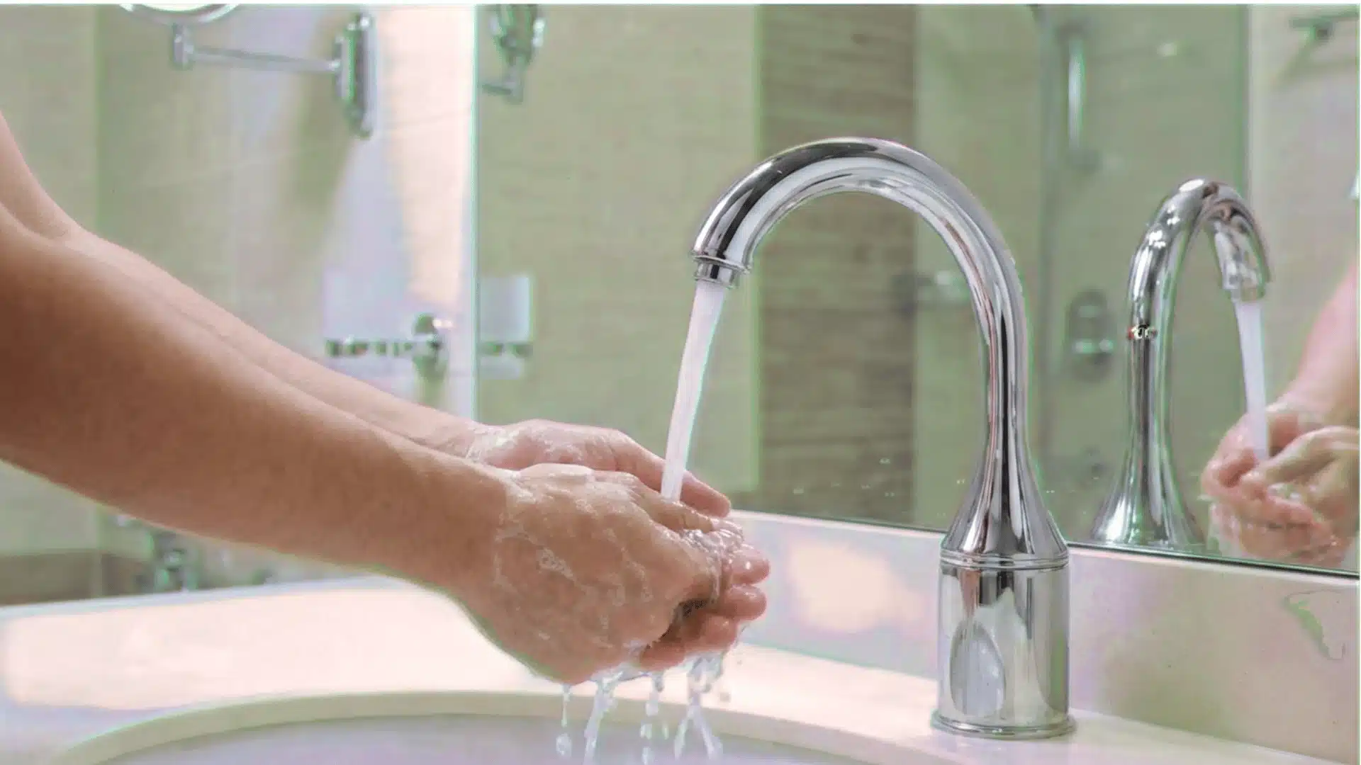 bathroom scene featuring a sleek chrome faucet with a curved, arc-shaped design