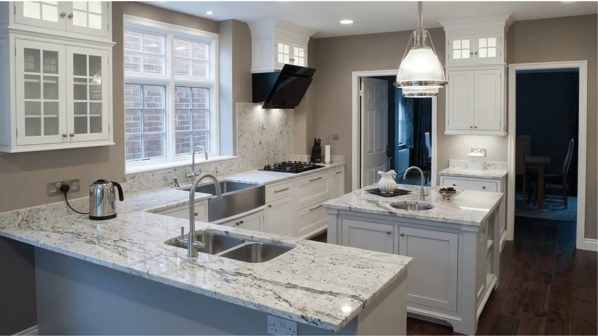 kitchen features detailed off-white cabinetry, intricate, and a substantial stone hood