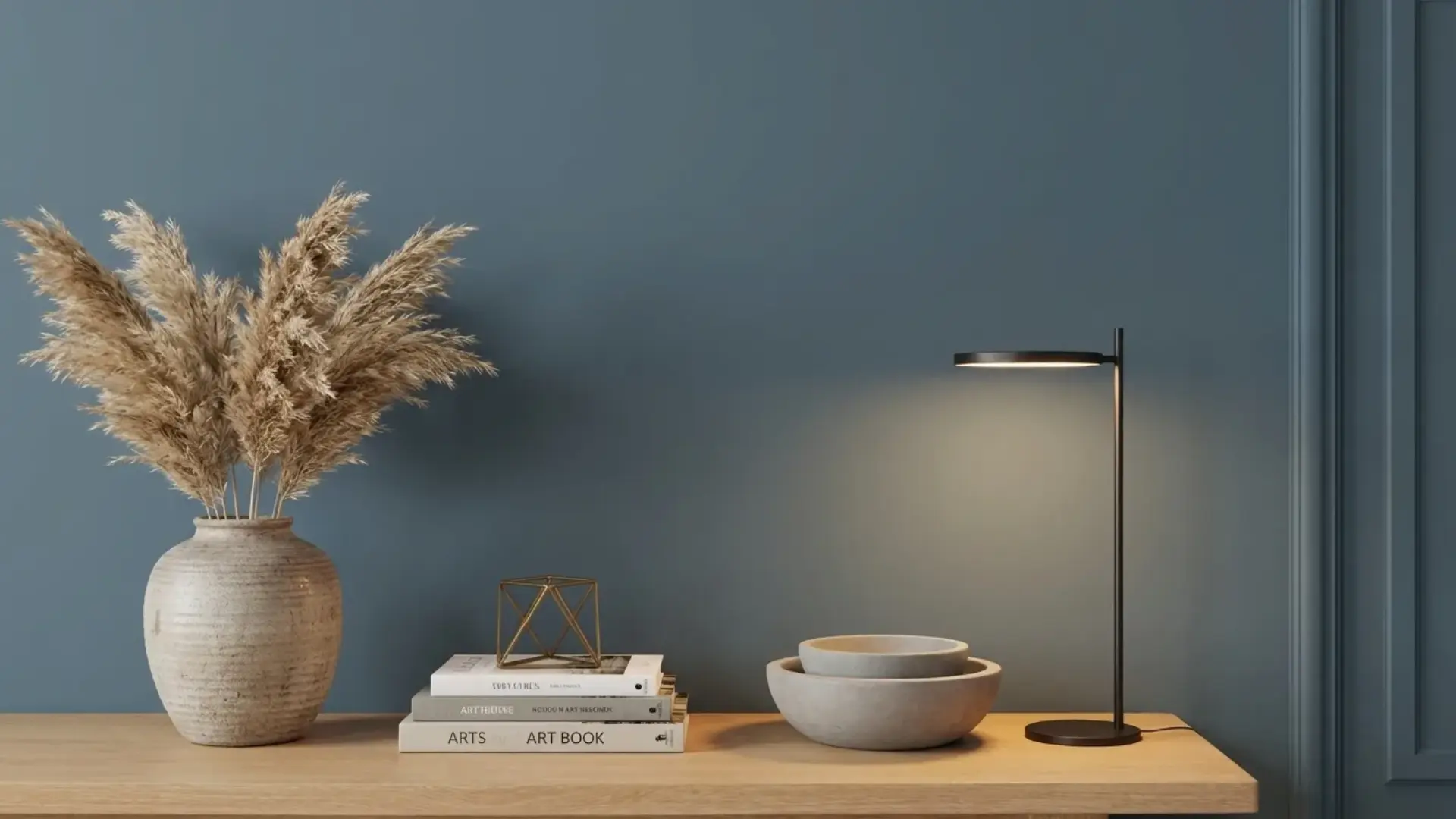 minimalist decor with pampas grass and a sleek lamp against a sherwin williams smoky blue wall with wood accents