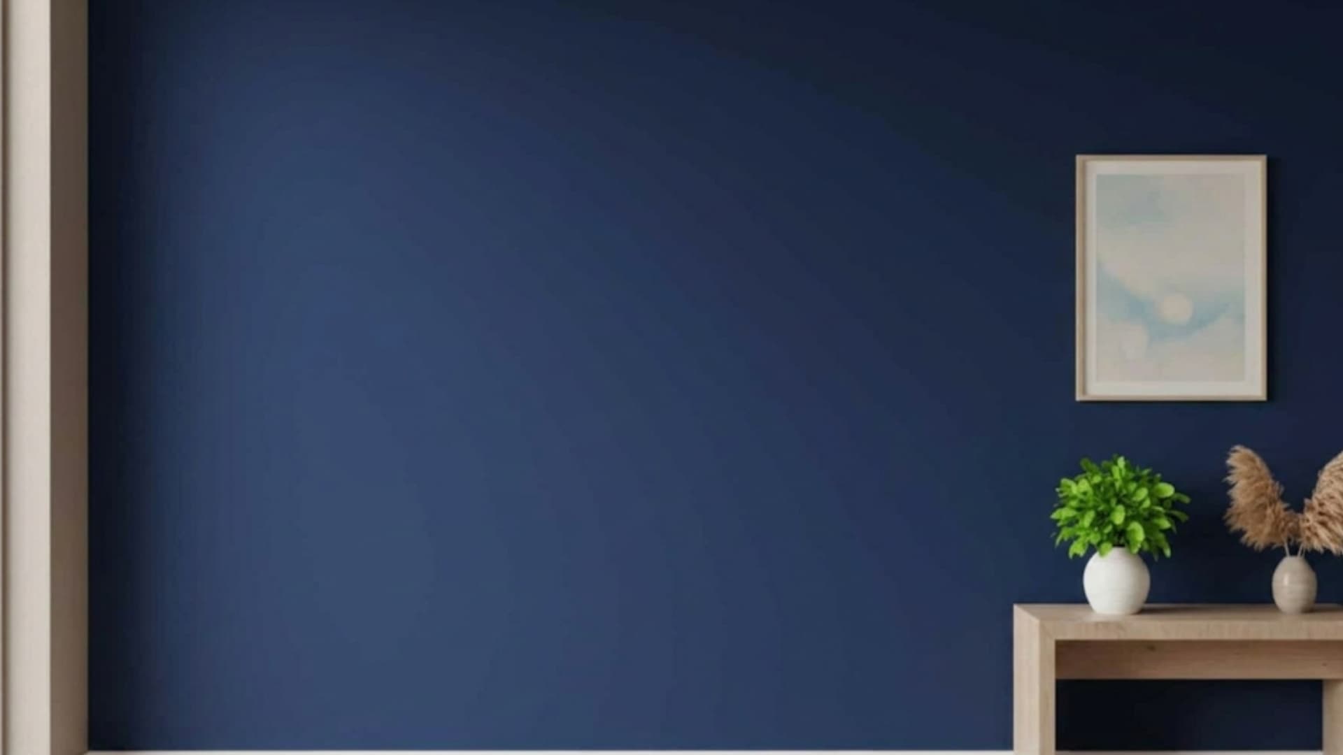 minimalistic room with a deep navy blue wall, a light wood table, plants, and a framed abstract print