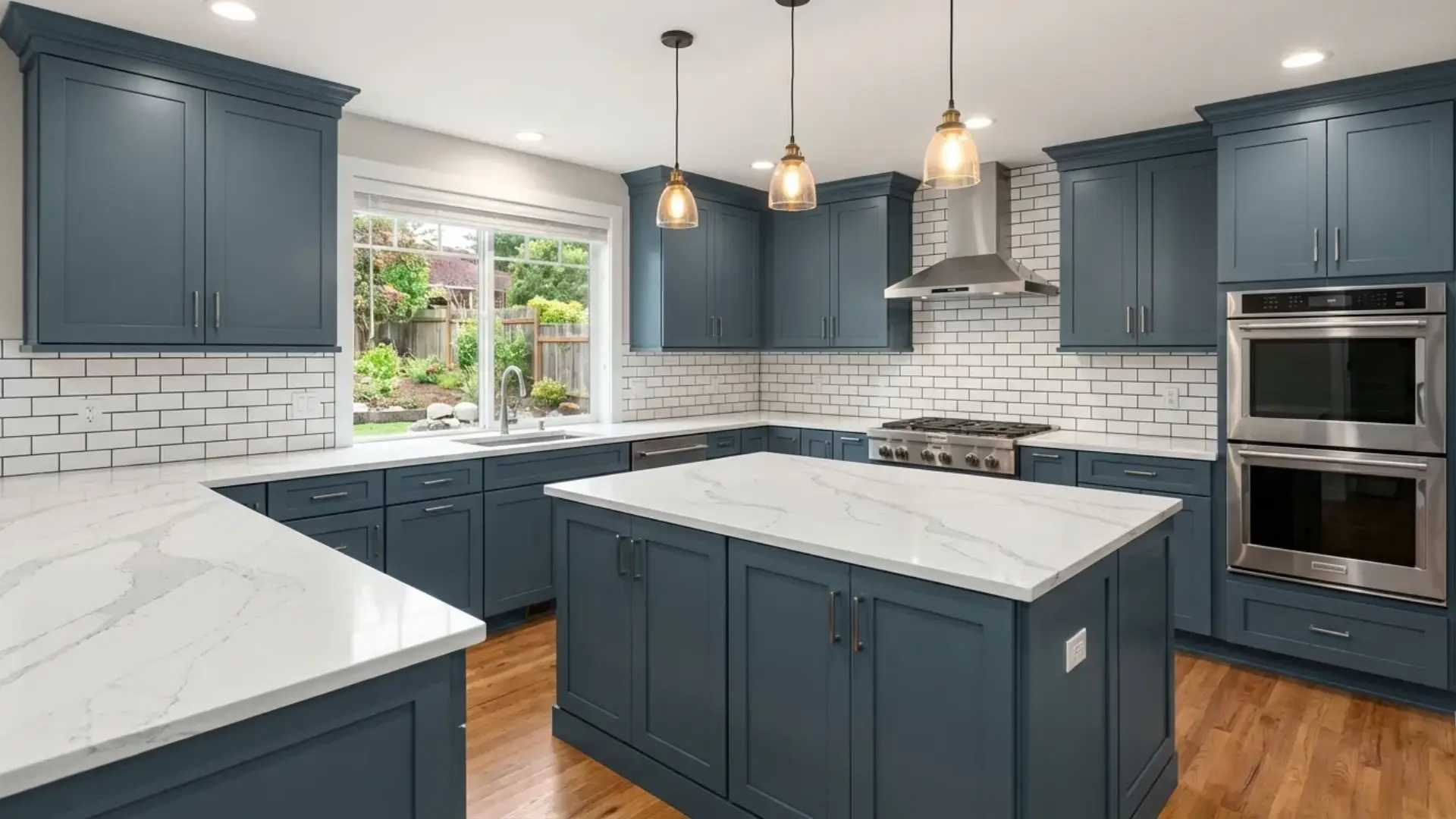 modern kitchen featuring smoky blue for kitchen cabinets white marble countertops and a classic subway tile backsplash