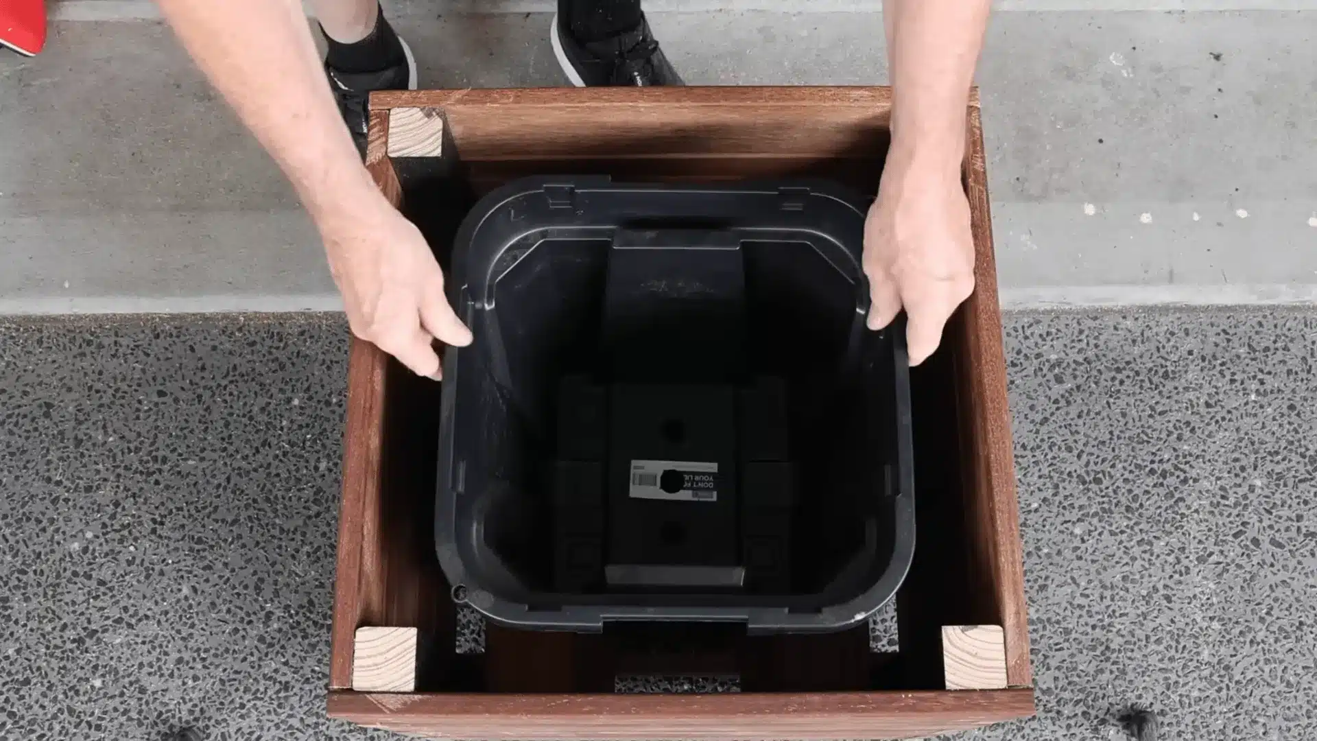placing a heavy plastic insert inside for building a base with drainage gaps to prevent rot