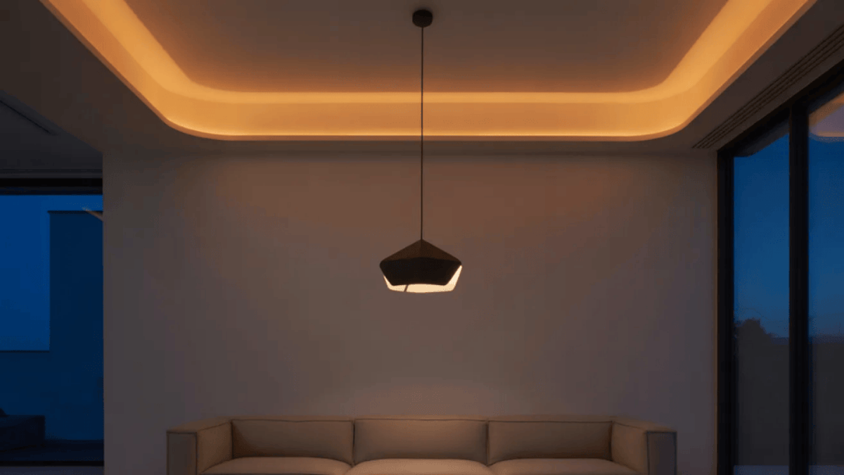 sparse minimal living room anchored by a single sculptural pendant light with bare walls and no decorative objects