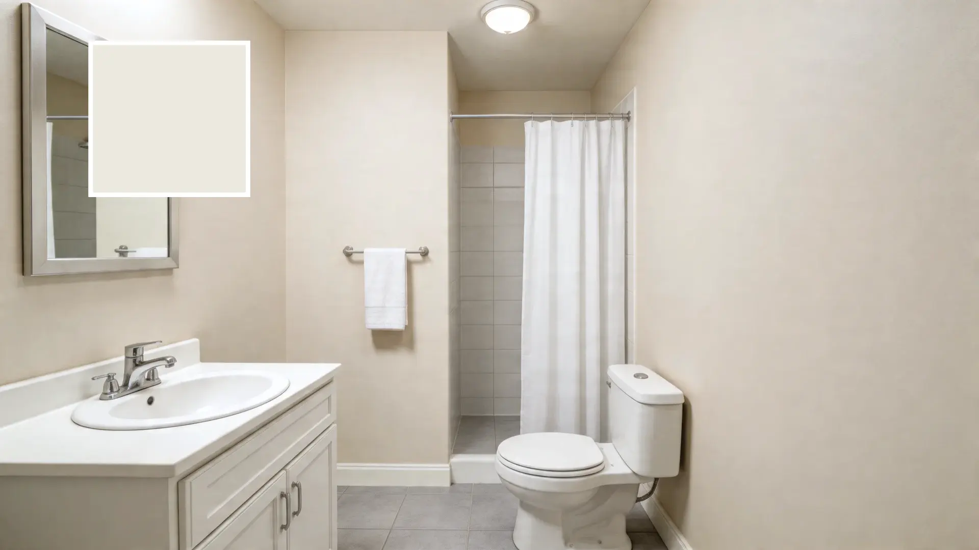 a small bathroom with warm off-white walls, white vanity, shower with curtain, and a paint color swatch overlay