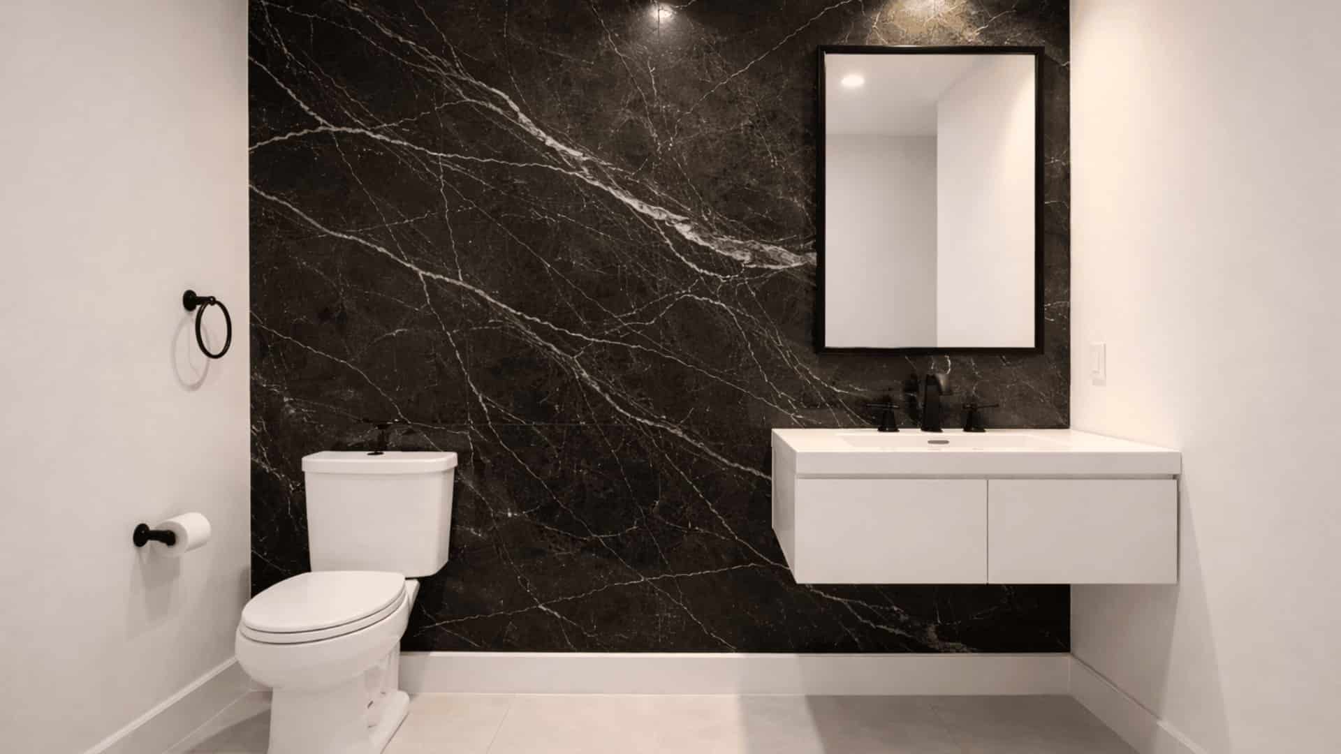bathroom with large black marble slab wall with white veining, white floating vanity and matte black fixtures