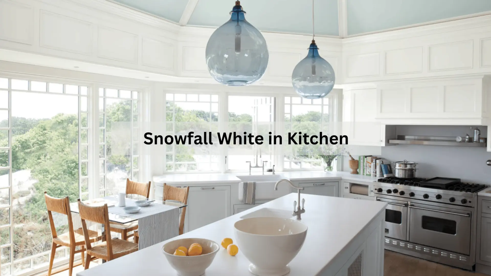 snowfall white color painted kitchen with cabinets, blue glass pendant lights, stainless steel range, and white island