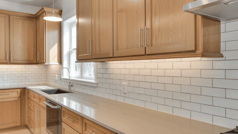 timeless kitchen cabinet colors with light oak cabinets and white backsplash in bright kitchen