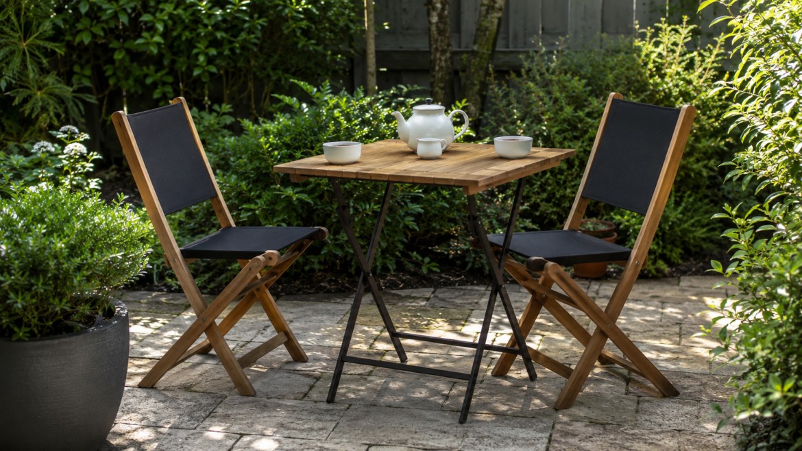 A cozy patio setup with two wooden chairs and a bistro table