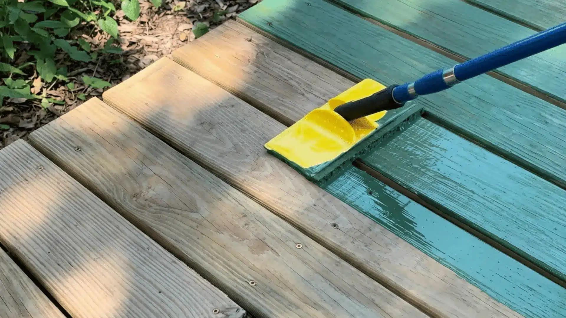 a high quality picture of the wood being paint with see green color in an outdoor location