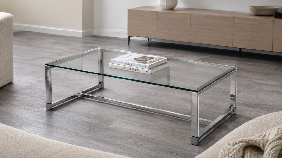 A modern living room features a sleek arcrylic table with two books on top