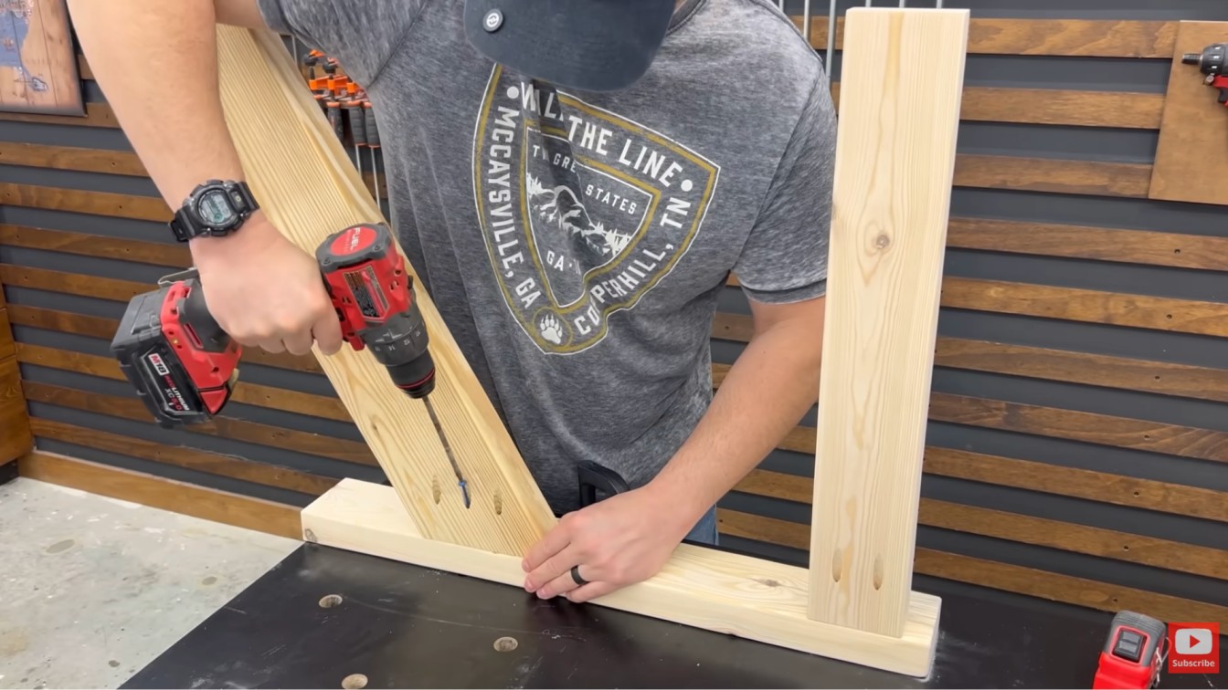 diy outdoor furniture chair frame assembly with drill fastening vertical supports and wooden side pieces