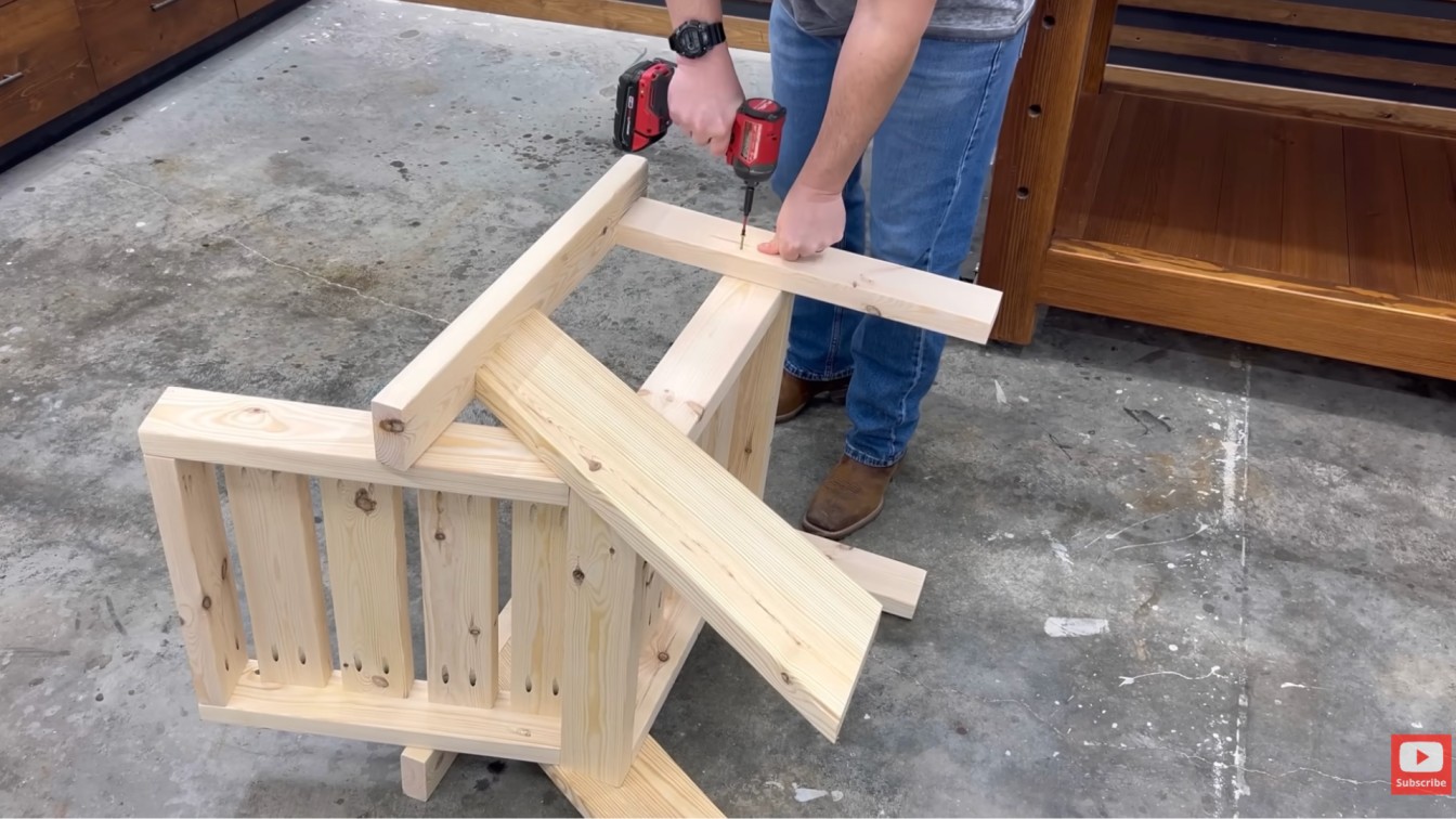 diy outdoor furniture chair build with angled back supports being attached to a simple wooden patio frame