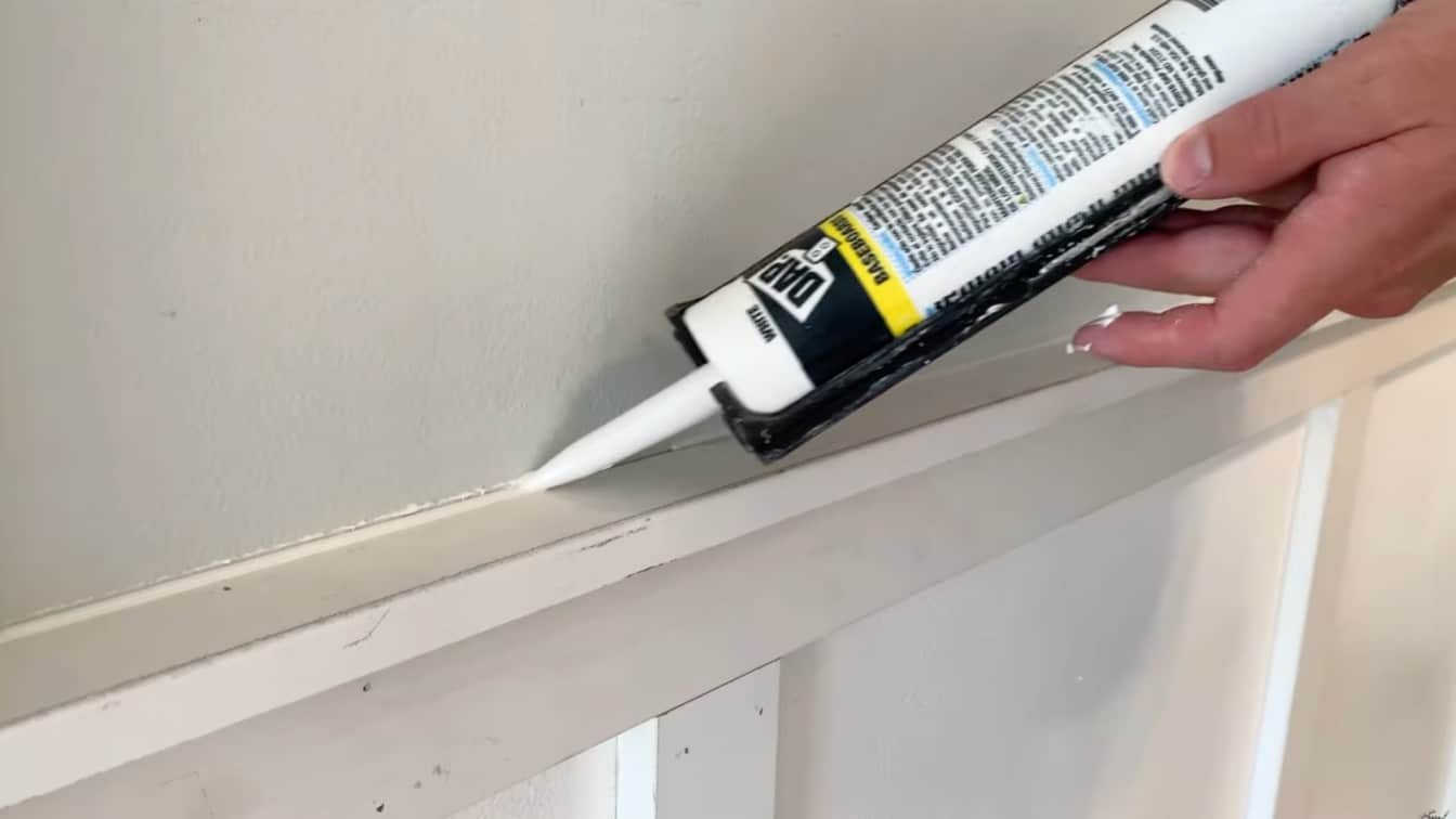 caulk being added along the top trim seam