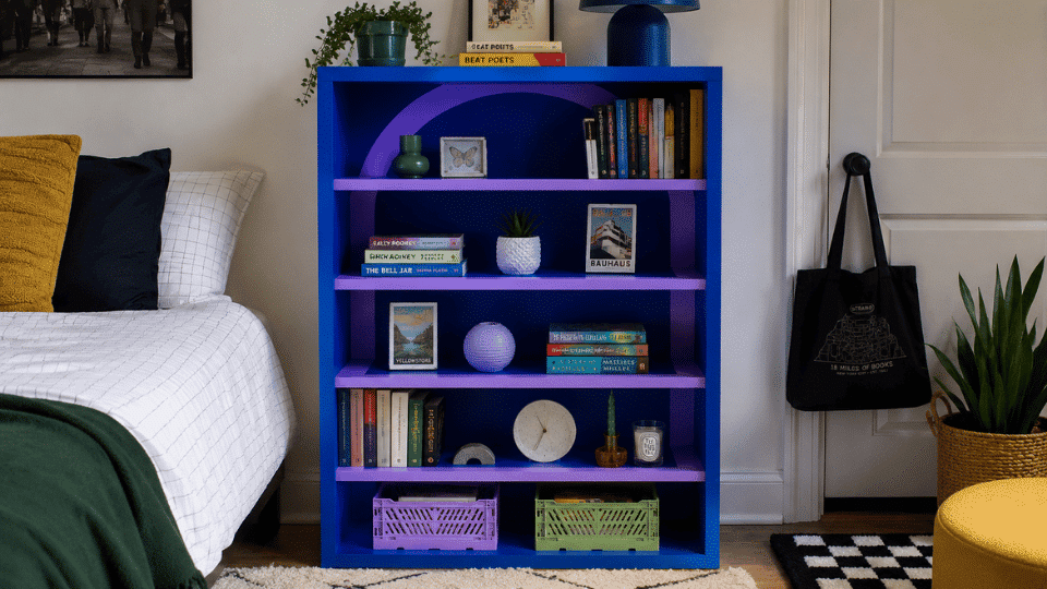 finished painted bookshelf placed in a styled bedroom