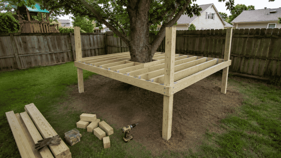 floor joists framed around a tree opening with safe trunk clearance