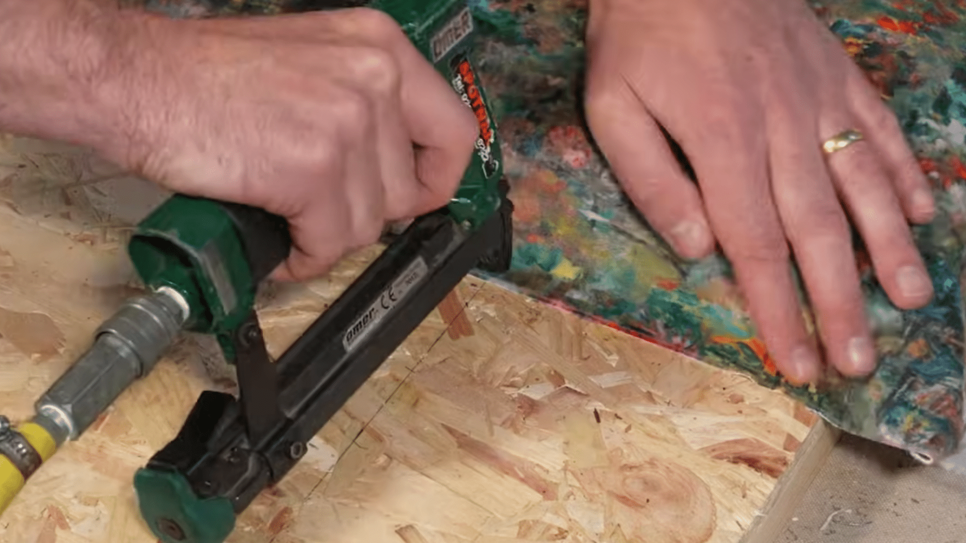 folding and stapling fabric corners neatly on upholstered headboard for tailored professional look