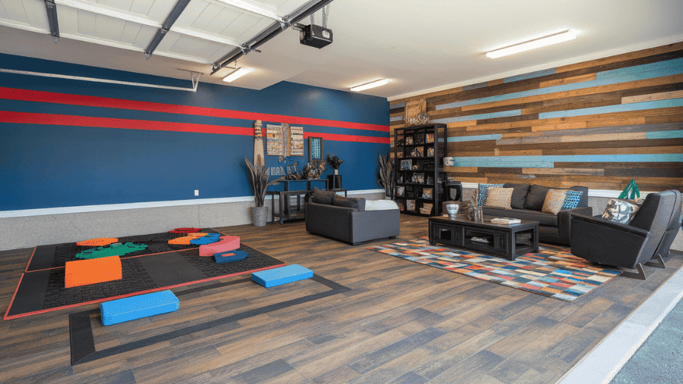 garage with painted walls, rugs and peel and stick flooring upgrade