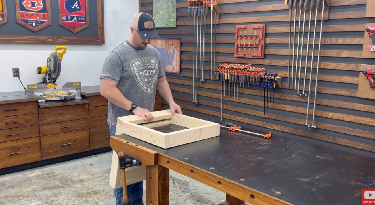 diy outdoor furniture project showing wooden seat frame parts arranged on a shop table before assembly
