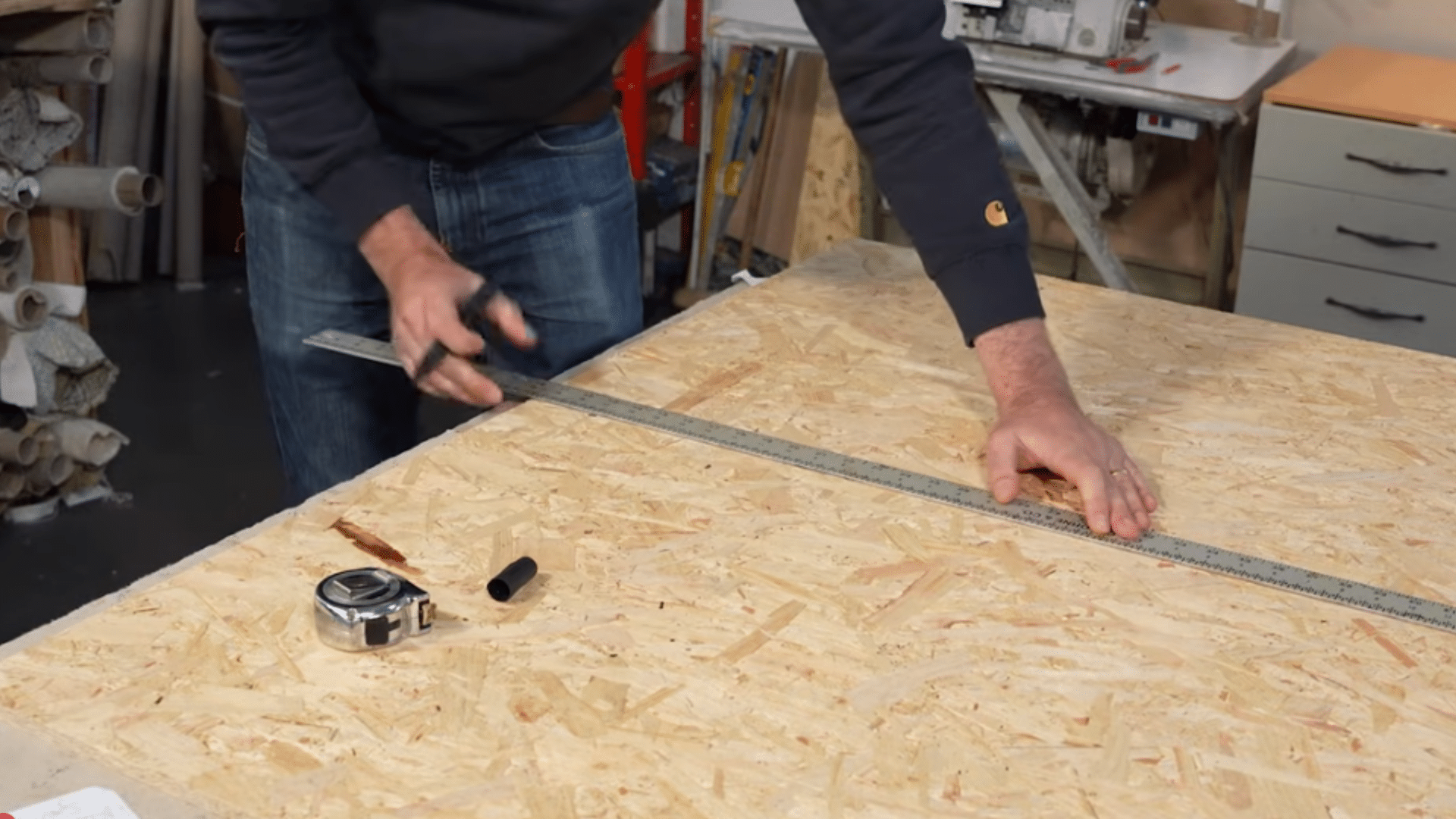 measuring and cutting osb board panels for a diy upholstered headboard project in home workshop (1)