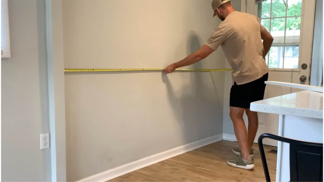 measuring the wall before marking the wainscoting layout