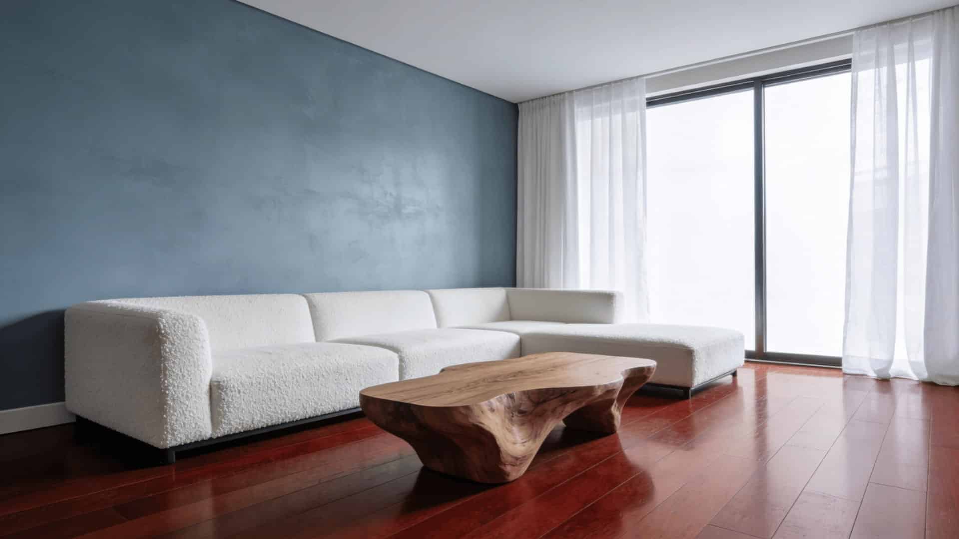 ontemporary living room with icy blue gray walls and rich reddish brown mahogany hardwood floors with minimalist white furniture