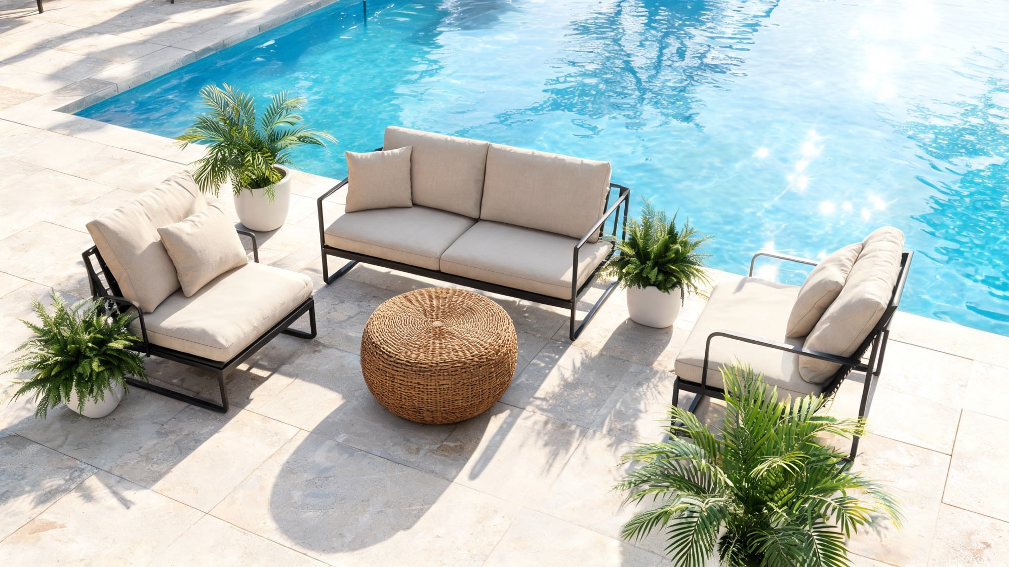 Outdoor wicker sofa and chairs with beige cushions and a round woven table