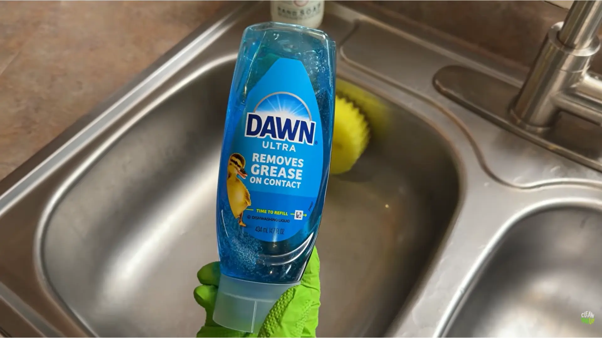 dawn dish soap held near sink for removing heavy grease from wood cabinets safely