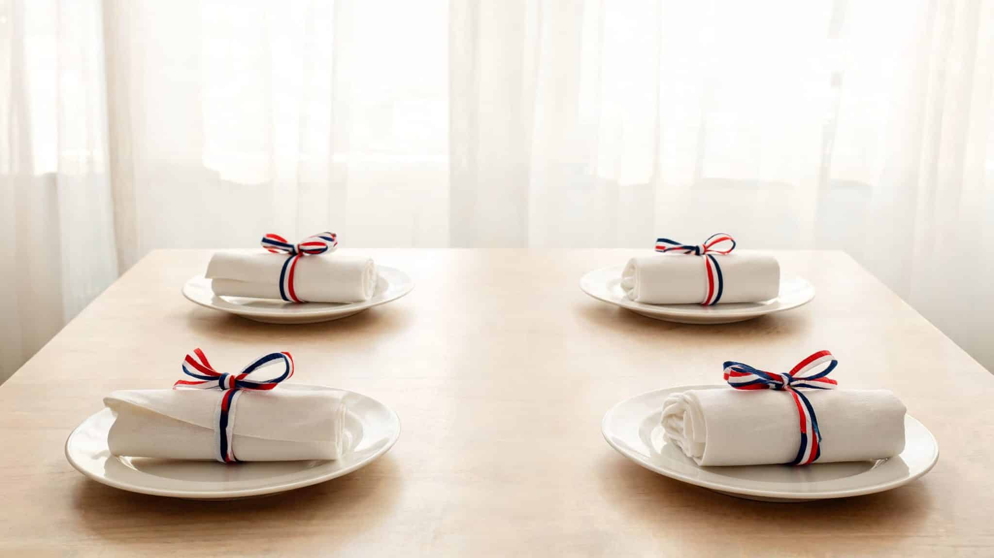 ribbon tied napkins on symmetrical dining table setup