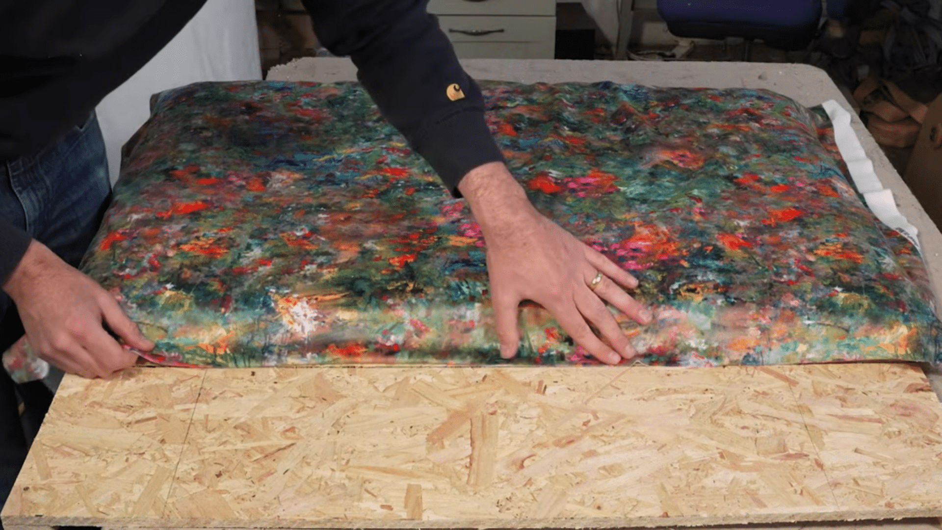 stretching and stapling fabric tightly onto upholstered headboard frame for smooth clean finish