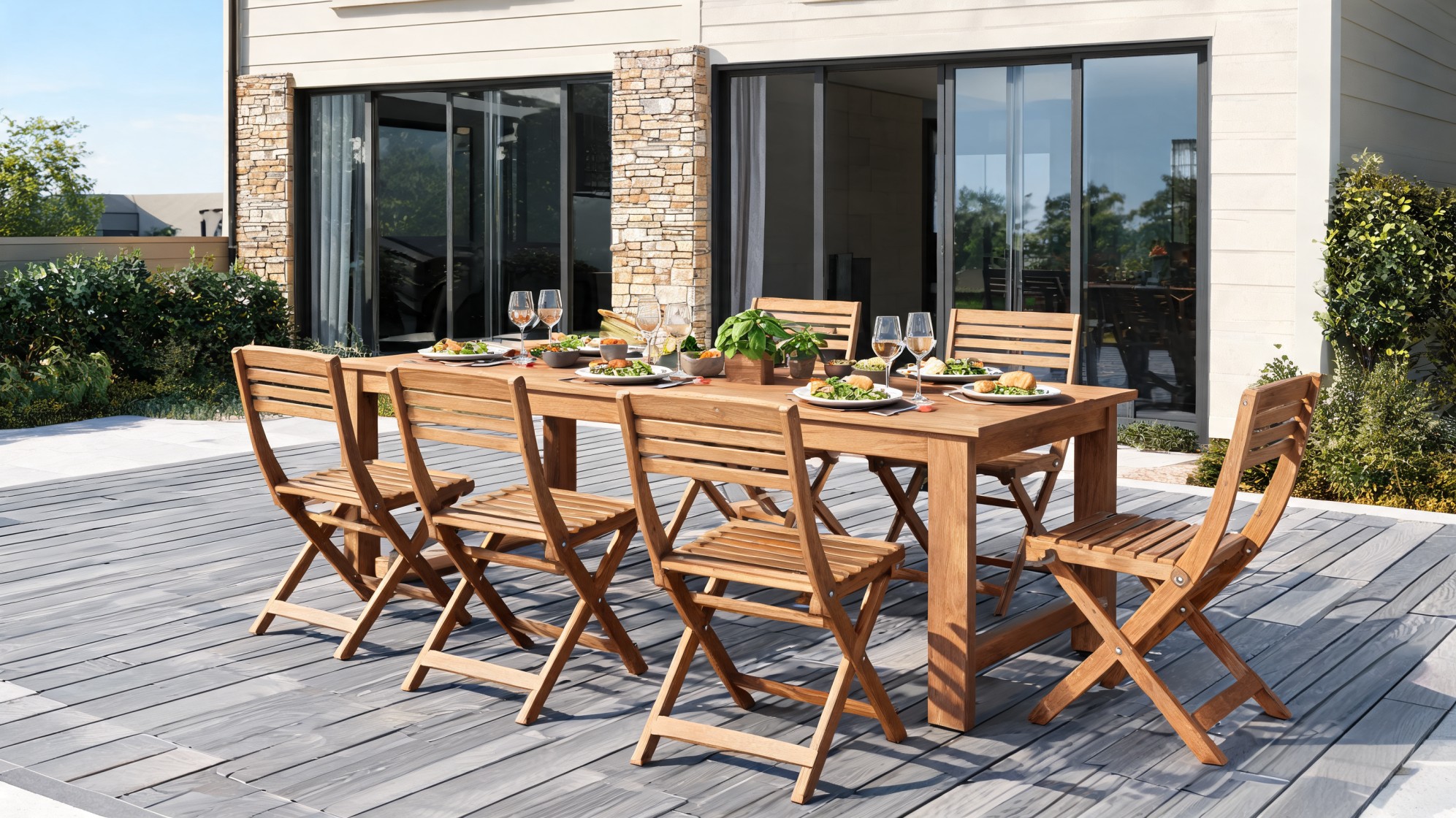 wooden patio dining table with matching folding chairs on a deck beside a modern home