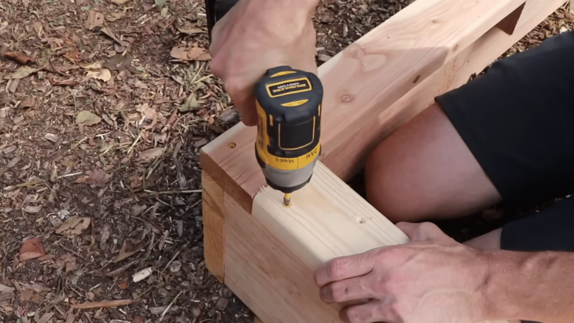 adding top rails and leveling the raised garden bed