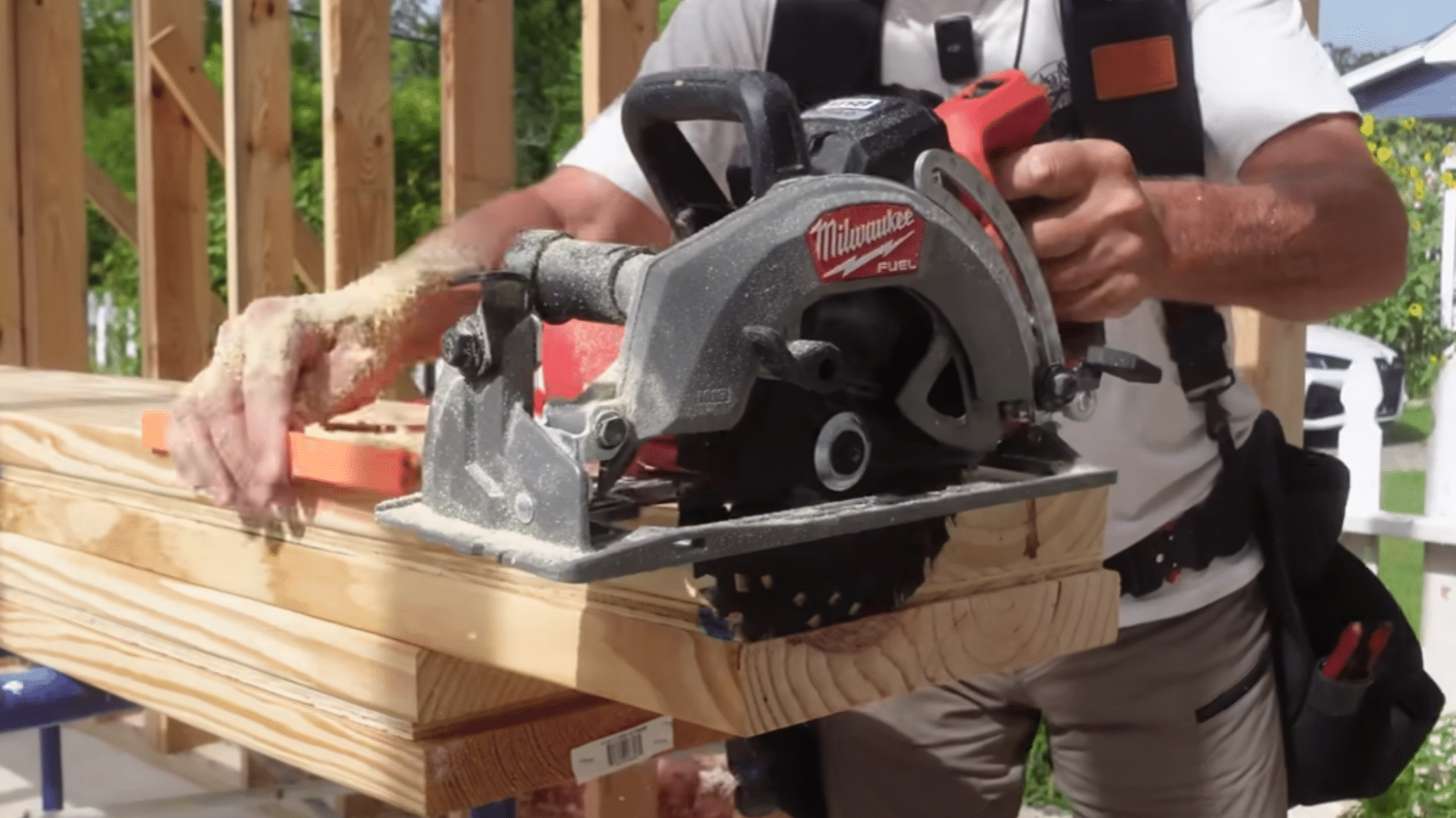 carpenter measuring and fitting short porch beam into framing pocket before installation (1)