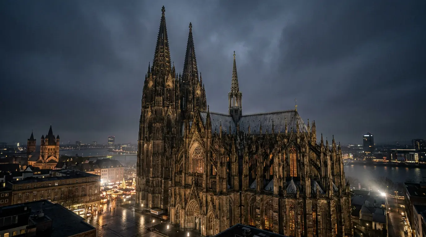 cologne cathedral with towering twin spires gothic stonework and glowing windows