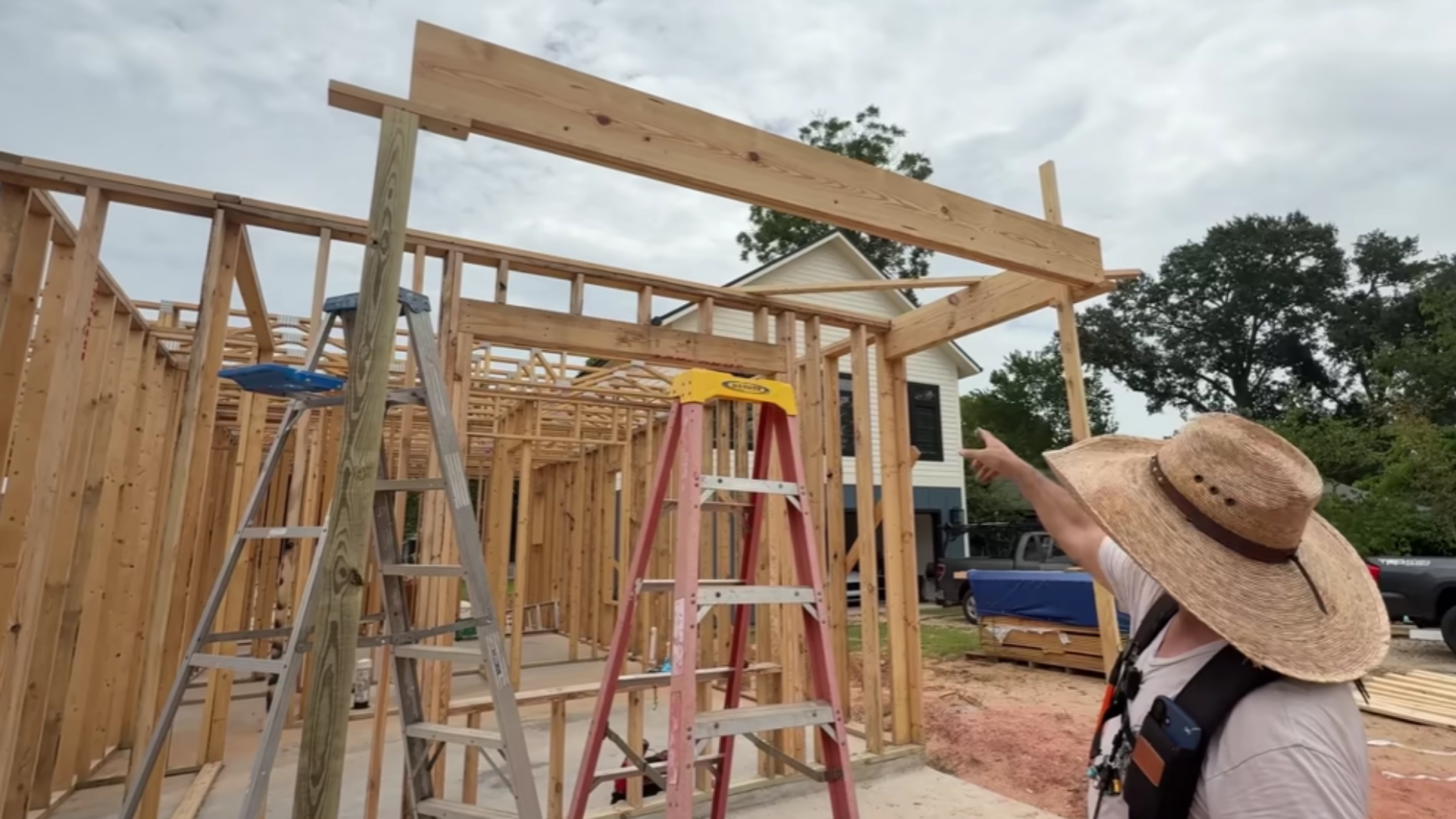 completed porch frame being checked for level alignment and parallel beam placement