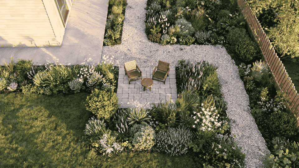 courtyard-style seating pocket with chairs, gravel floor and overhead mild garden layout view