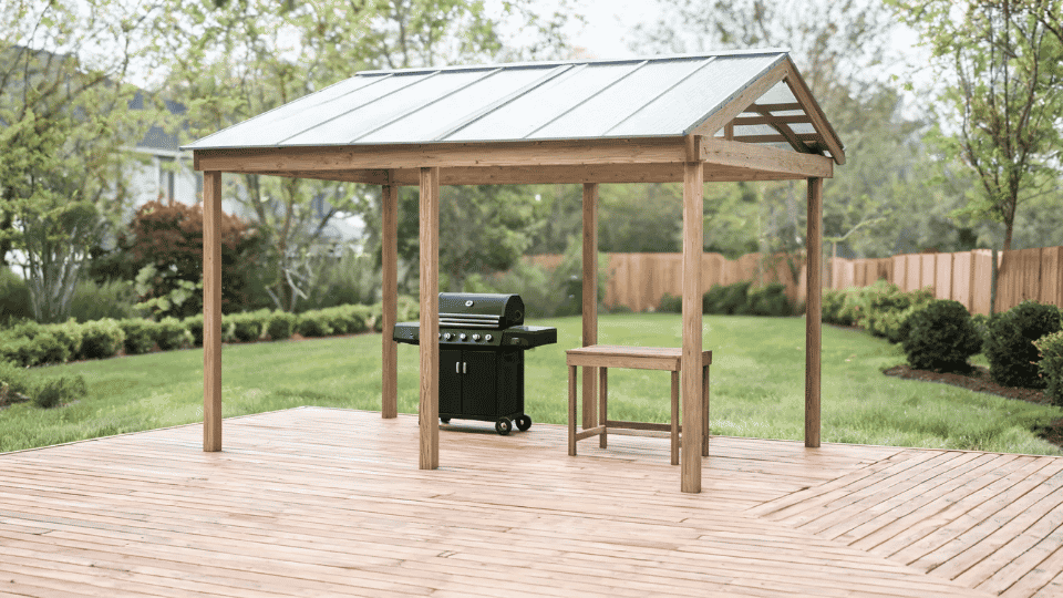 covered deck ideas on a budget with a grill station in soft shade under a small mini roof