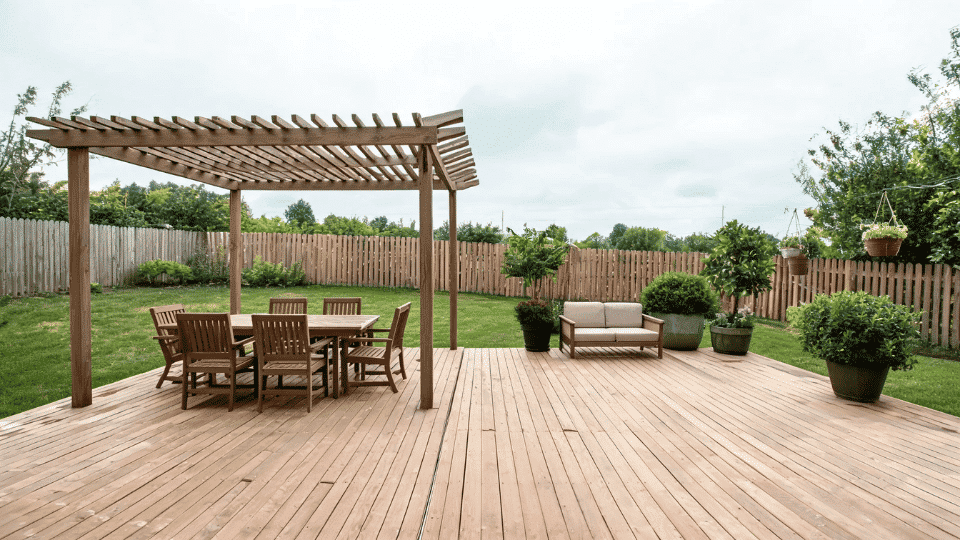 covered deck ideas on a budget with dining chairs softly shaded on a half-covered deck layout