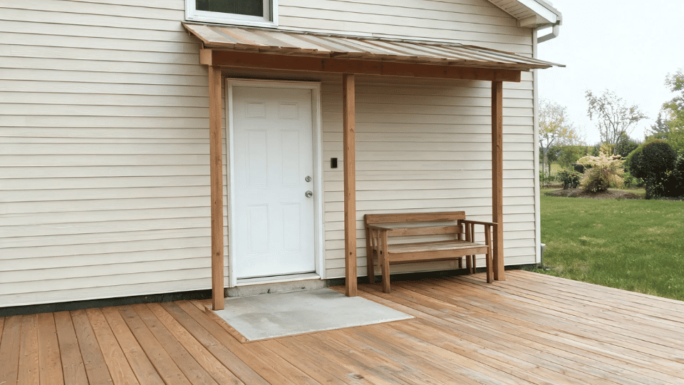 covered deck ideas on a budget with a lean-to doorway cover softly shading a small bench and door