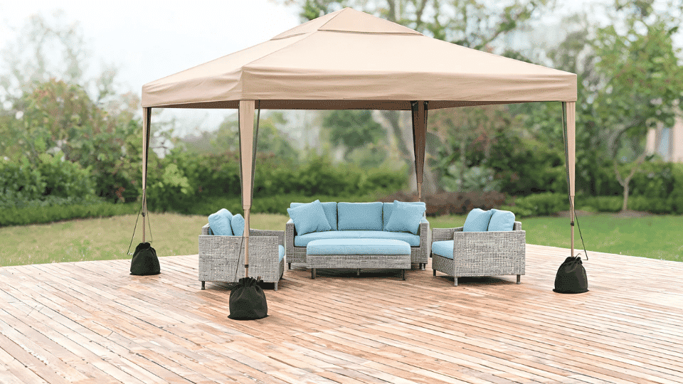 covered deck ideas on a budget with sofa and chairs in soft shade under a pop-up canopy