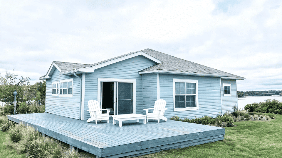 deck color ideas with coastal blue gray boards and white furniture on a pale blue lake house