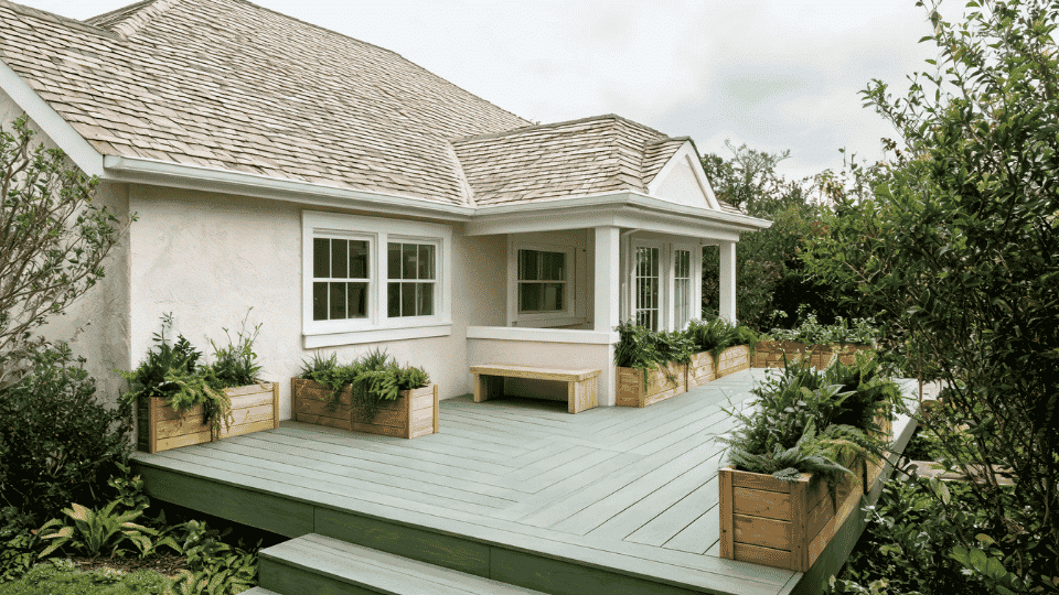 deck color ideas with soft sage boards and natural wood accents on a cream cottage deck