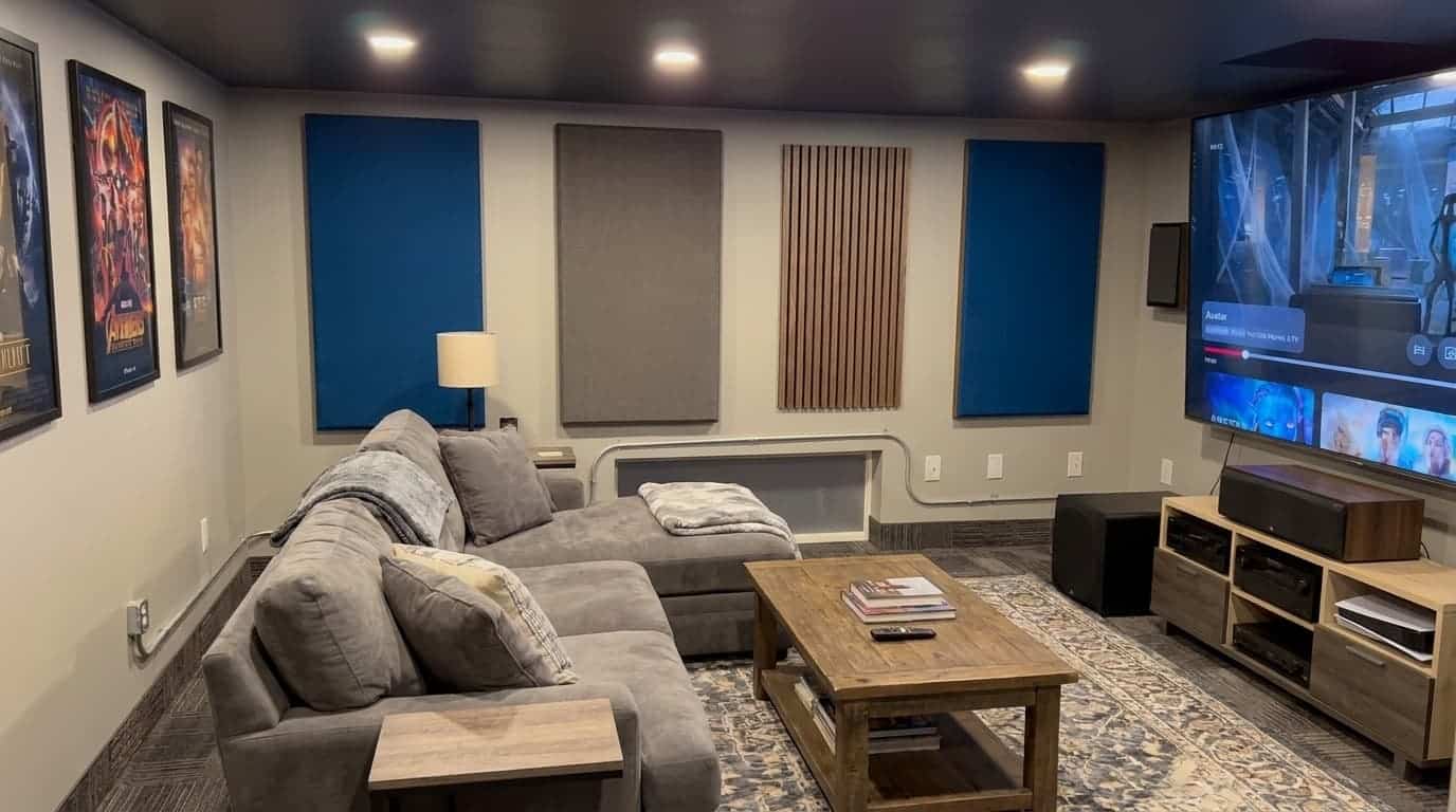 finished acoustic panels hanging in a small home theater with clear walls and warm lighting