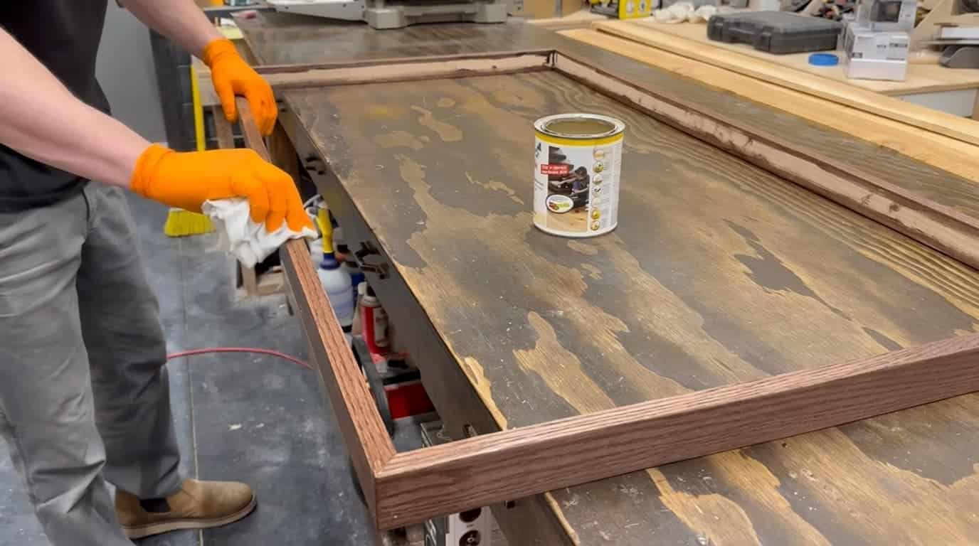 finished oak wood trim strips drying after stain beside a fabric covered acoustic panel