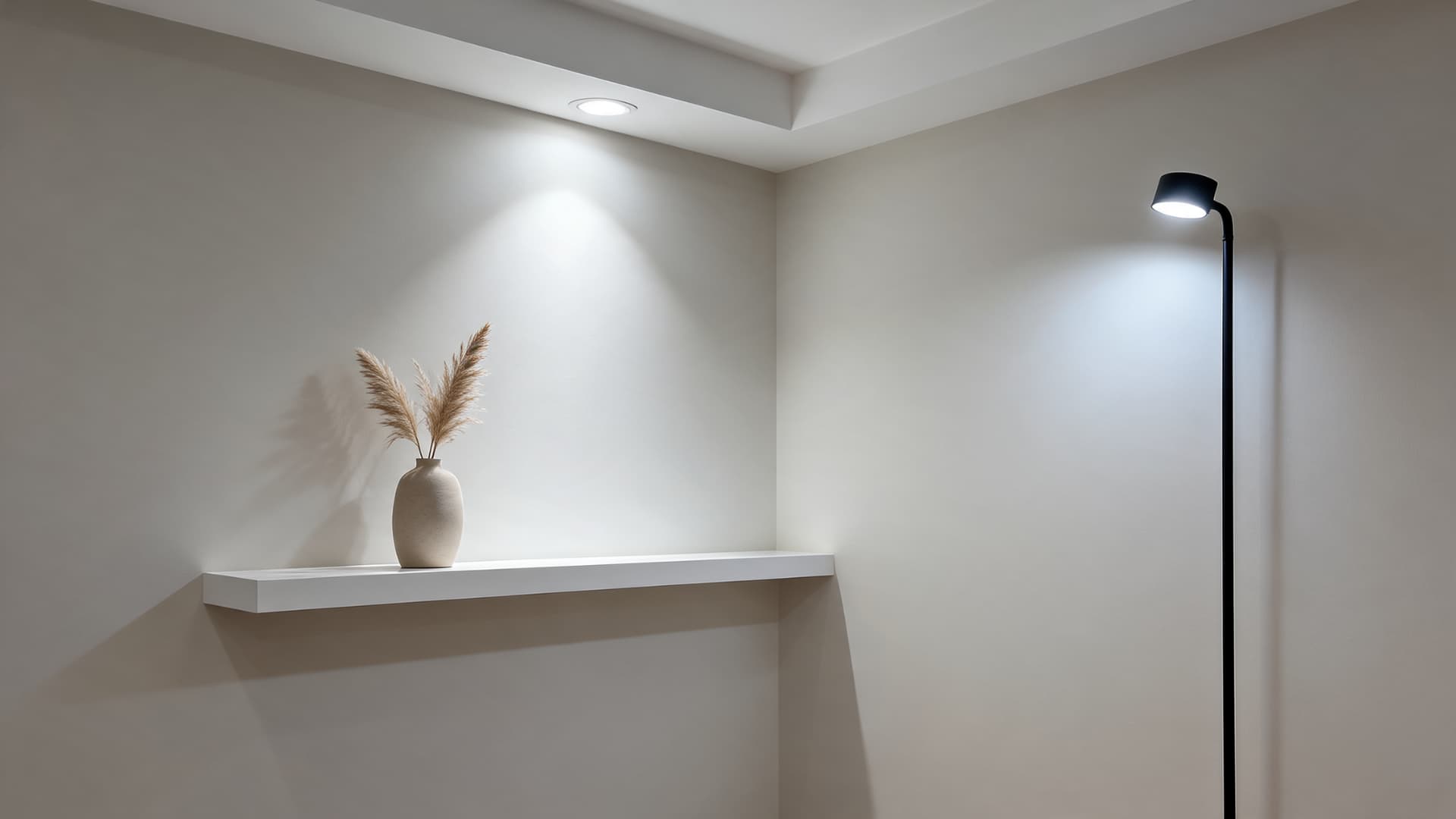 eider white wall under cool artificial lighting with soft shadows and simple neutral shelf decor
