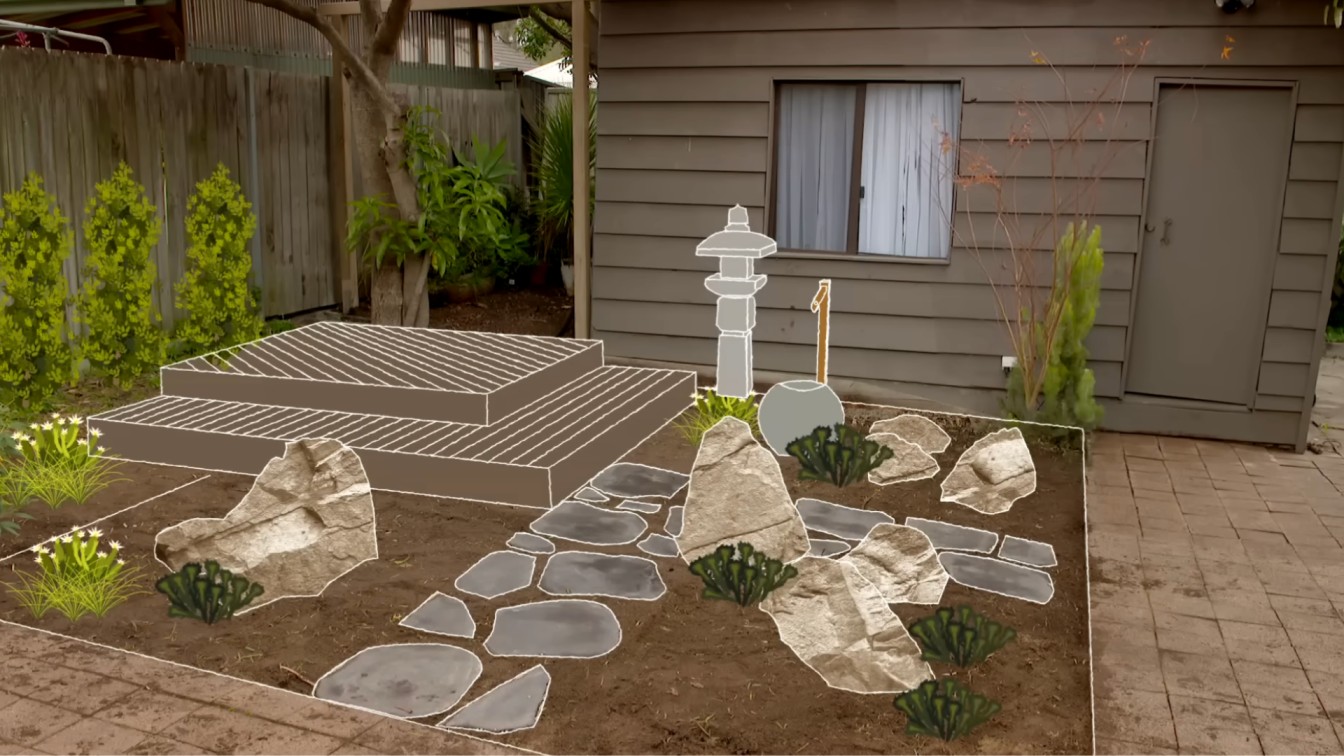 finished backyard garden with stone path, boulders, shrubs, mulch, and small bird bath feature