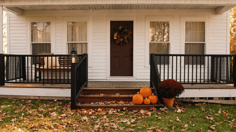 front porch decorating ideas with pumpkins, mum planter, lantern, wreath, and neat fall decor