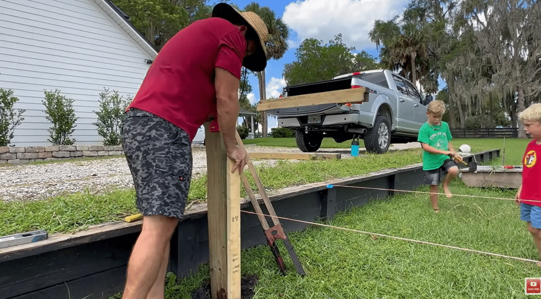 dock posts being set into the shoreline soil with water pressure for how to build a dock