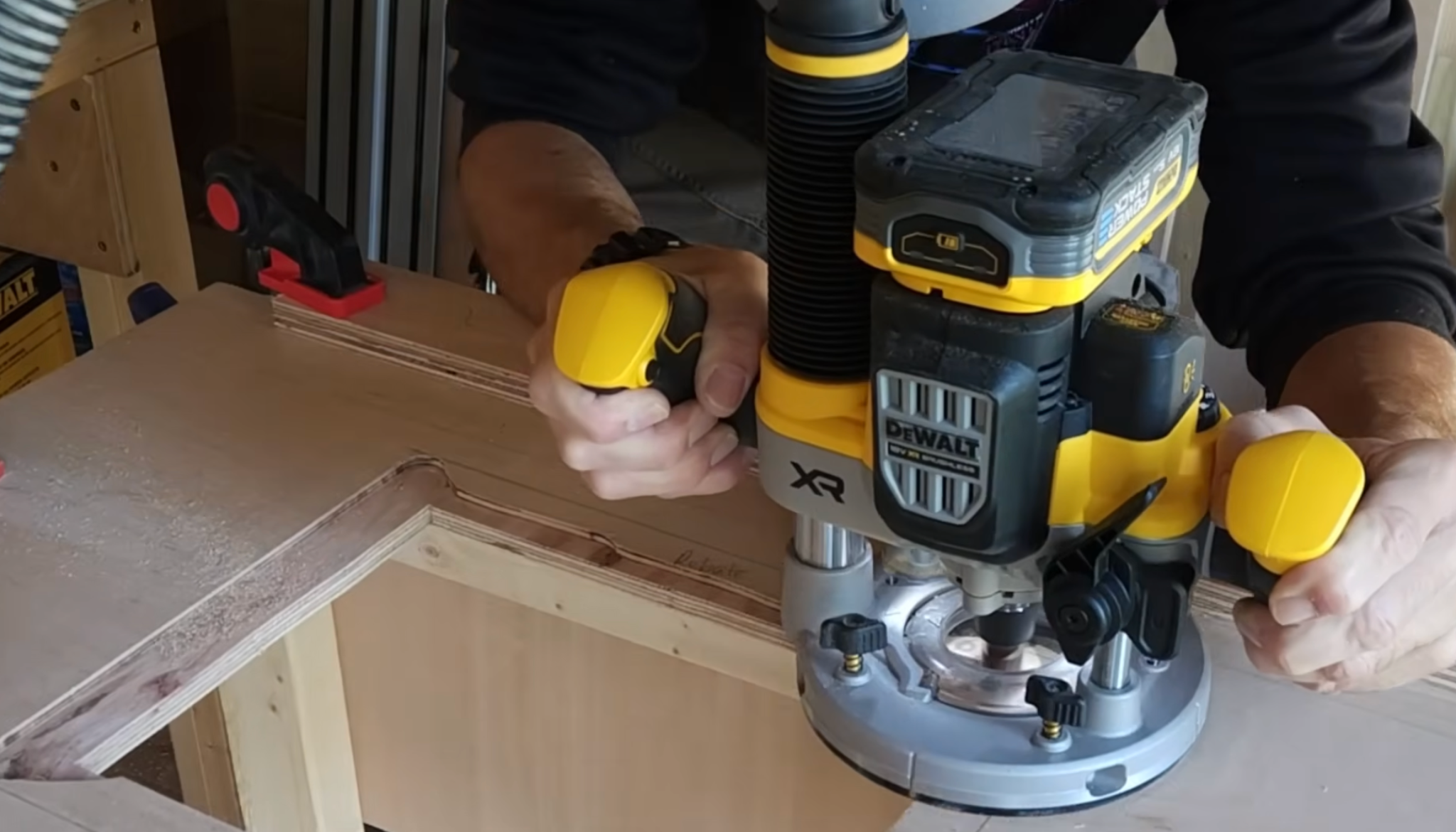 man creating the base plate rebate using a plunge router