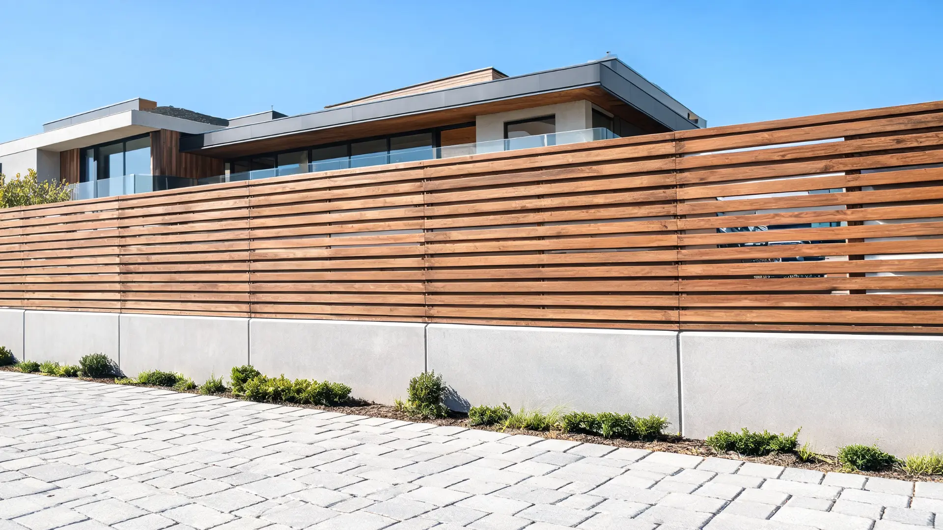 modern wood and concrete fence with warm slats, clean lines, and a sleek architectural outdoor design