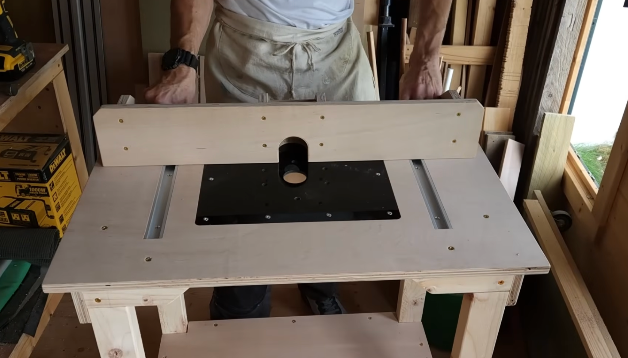 person attaching and aligning the router table fence ensuring it is square and slides smoothly